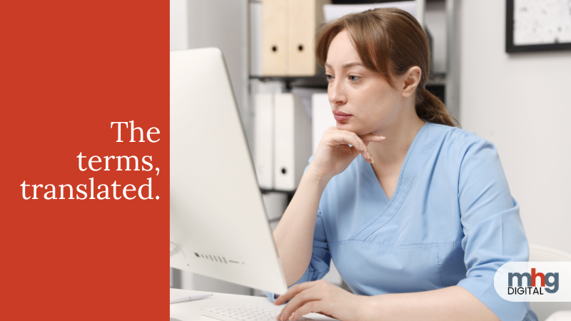 Occupational therapist at computer reviewing digital marketing terms for their practice.